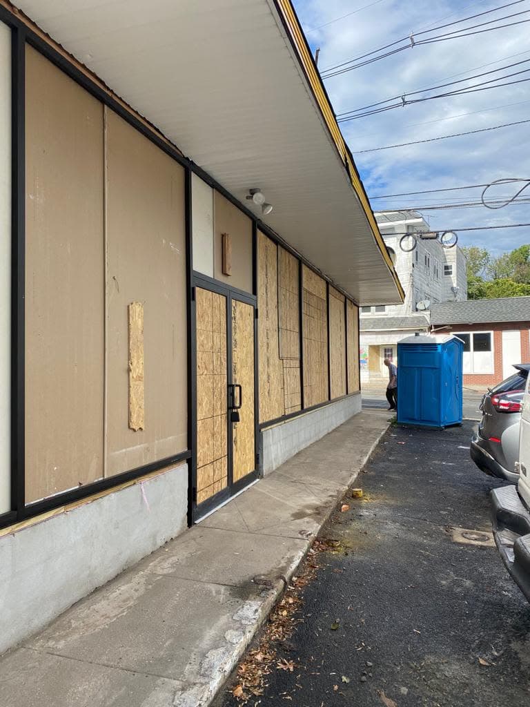 Black aluminum storefront framing across a commercial facade in Hillside, New Jersey.