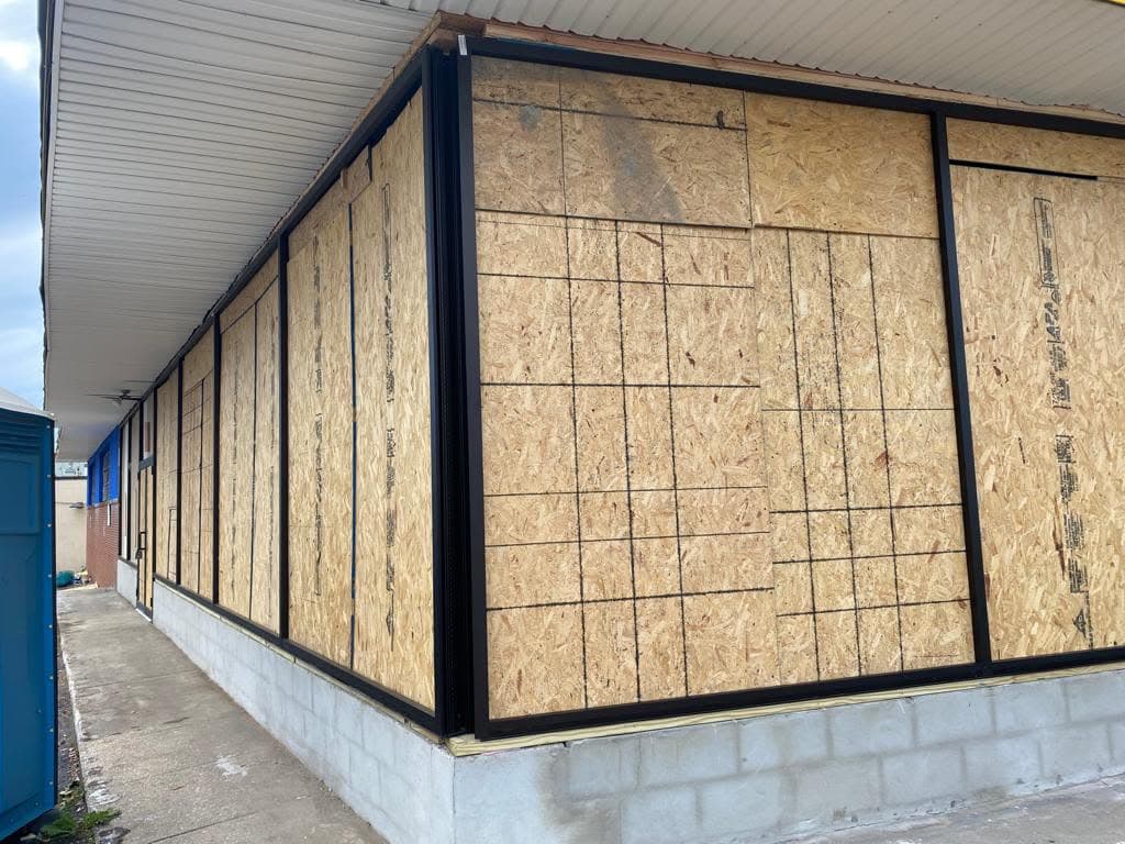 Corner view of the black storefront framing during construction in Hillside, New Jersey.