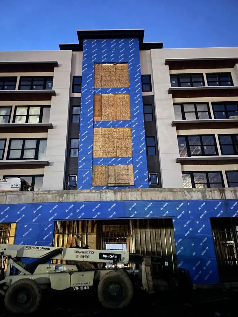 Multi-story facade with black-framed windows and storefront openings in Cliffside Park, New Jersey.
